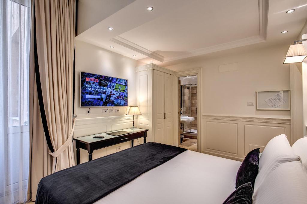 Postel nebo postele na pokoji v ubytování Hotel dei Quiriti Suite