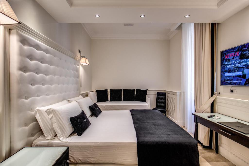 Postel nebo postele na pokoji v ubytování Hotel dei Quiriti Suite