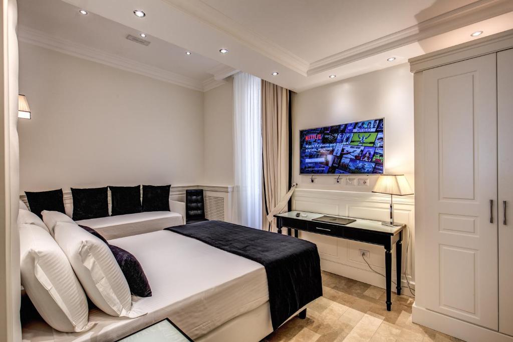 TV a/nebo společenská místnost v ubytování Hotel dei Quiriti Suite