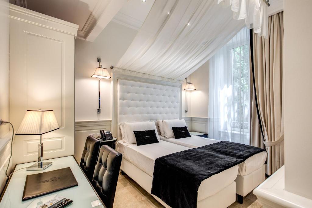 Postel nebo postele na pokoji v ubytování Hotel dei Quiriti Suite