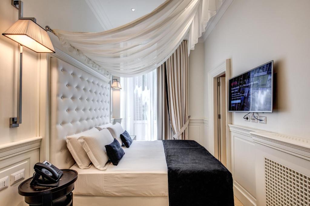 Postel nebo postele na pokoji v ubytování Hotel dei Quiriti Suite