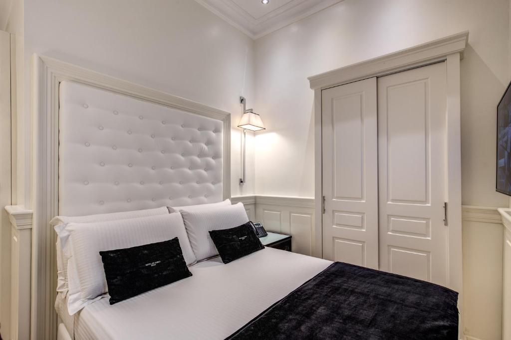 Postel nebo postele na pokoji v ubytování Hotel dei Quiriti Suite
