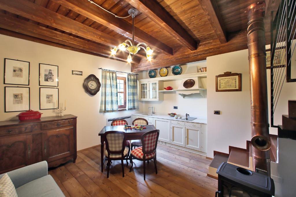 a kitchen and dining room with a table and chairs at Agriturismo Malabaila in Canale