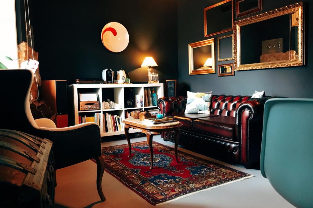 a living room with a leather couch and a table at el gran sueño Boutique Hotel & Apartamentos - Adults Only in Pintueles
