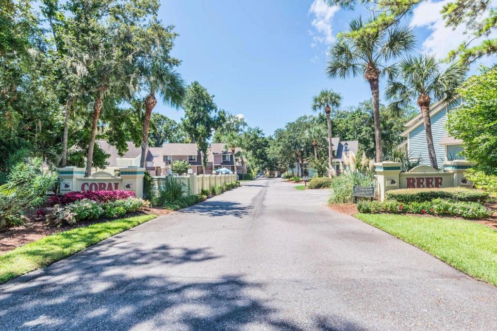 a street in a neighborhood with palm trees at Coral Reef Resort in Hilton Head Island