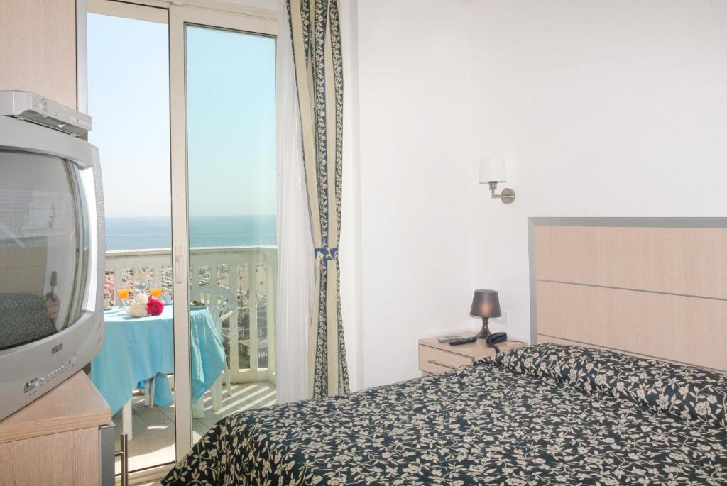 a bedroom with a bed and a view of the ocean at Residence T2 in Rimini