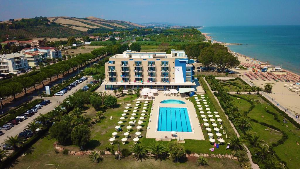 an aerial view of a hotel with a pool and the ocean at Roses Hotel in Roseto degli Abruzzi
