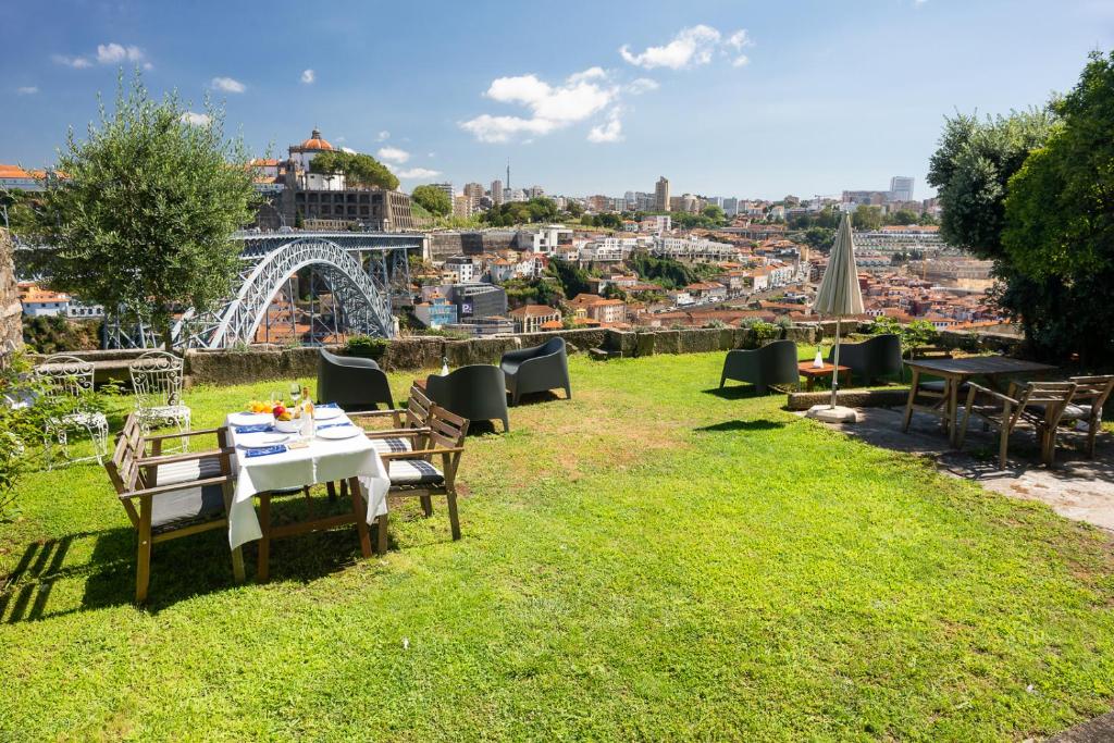 a table and chairs on the grass with the eiffel tower at Manor House Porto in Porto