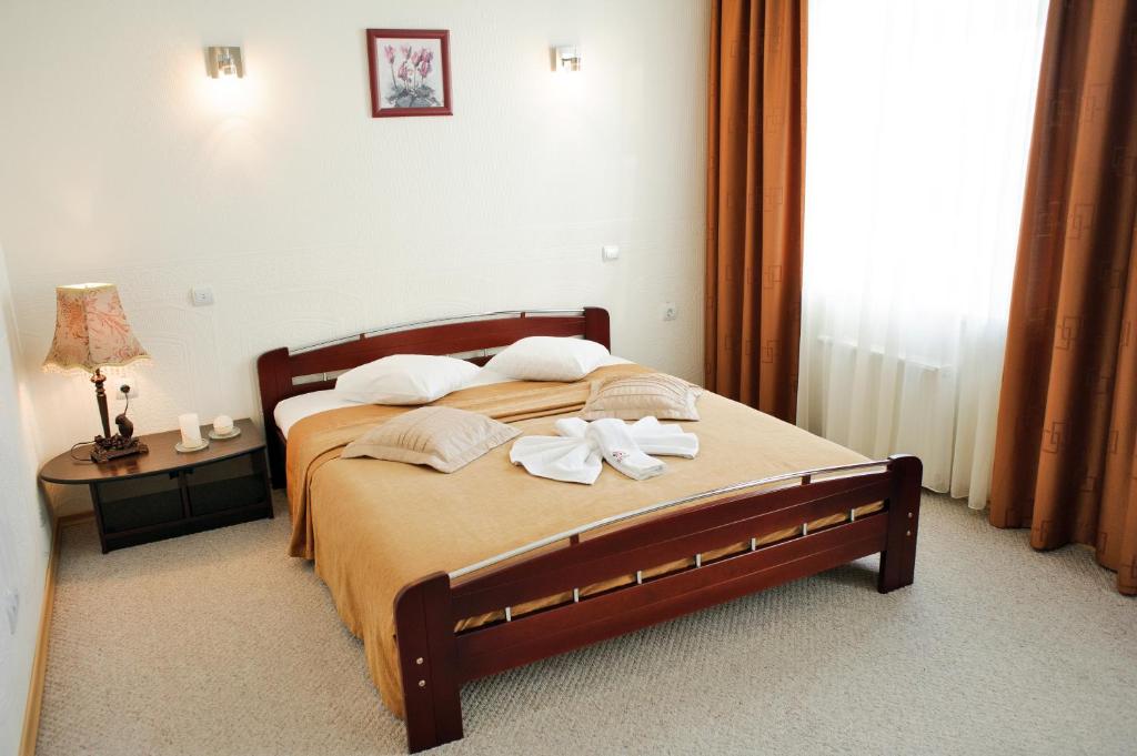 Postel nebo postele na pokoji v ubytování Dinaburg SPA Hotel