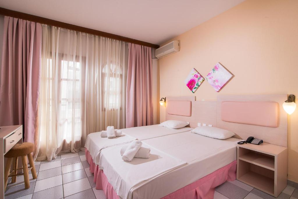 Postel nebo postele na pokoji v ubytování Hotel Calypso