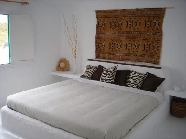a bedroom with a large white bed with pillows at Casa Callao in Famara