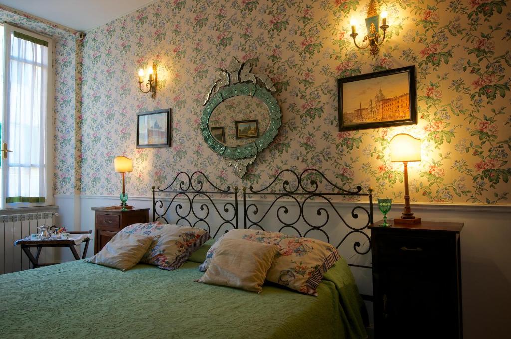 a bedroom with a bed with two pillows and a mirror at Guest House Arco Dei Tolomei in Rome