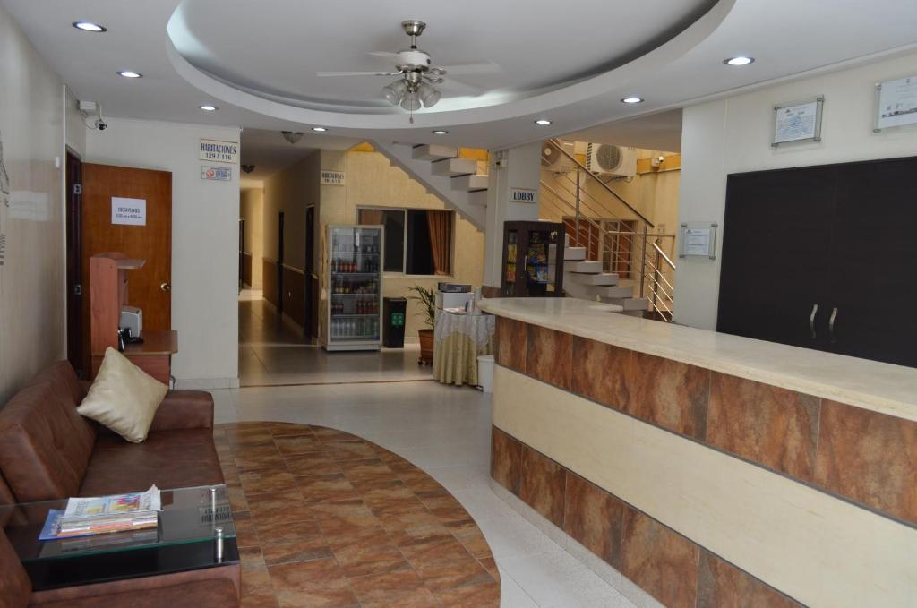 a lobby with a bar and a couch and stairs at Hotel Plaza Cúcuta Center in Cúcuta