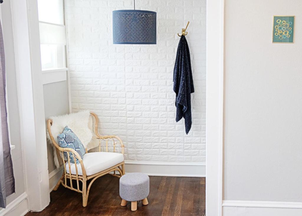 a hallway with a chair and a pendant light at Local Hotspot SHELTER IN PLACE HERE! in Dallas