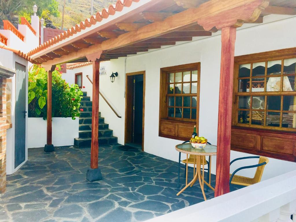 a patio of a house with a table and stairs at Casa Manuela 2 in Fuencaliente de la Palma
