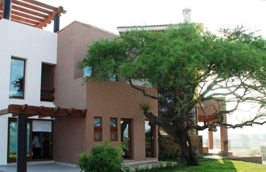 a house with a tree in front of it at Casa Toscana - Coronado 18 in San Miguel de Allende