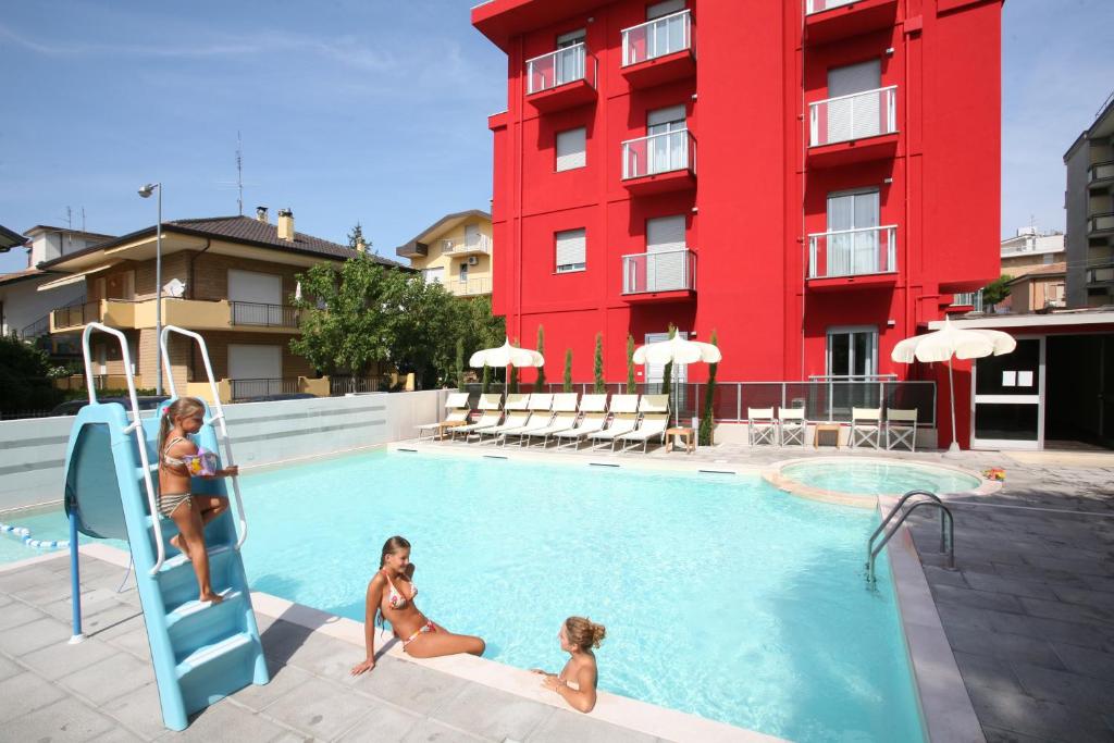 two girls playing in a swimming pool in a hotel at Residence Altomare in Riccione