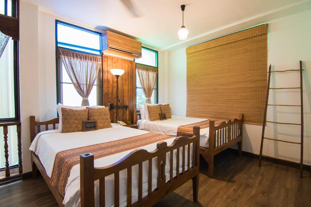 Кровать или кровати в номере Pak Chiang Mai