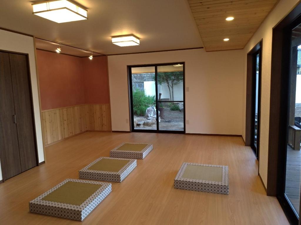 a room with four mats on a wooden floor at Touchian / Vacation STAY 1026 in Okayama