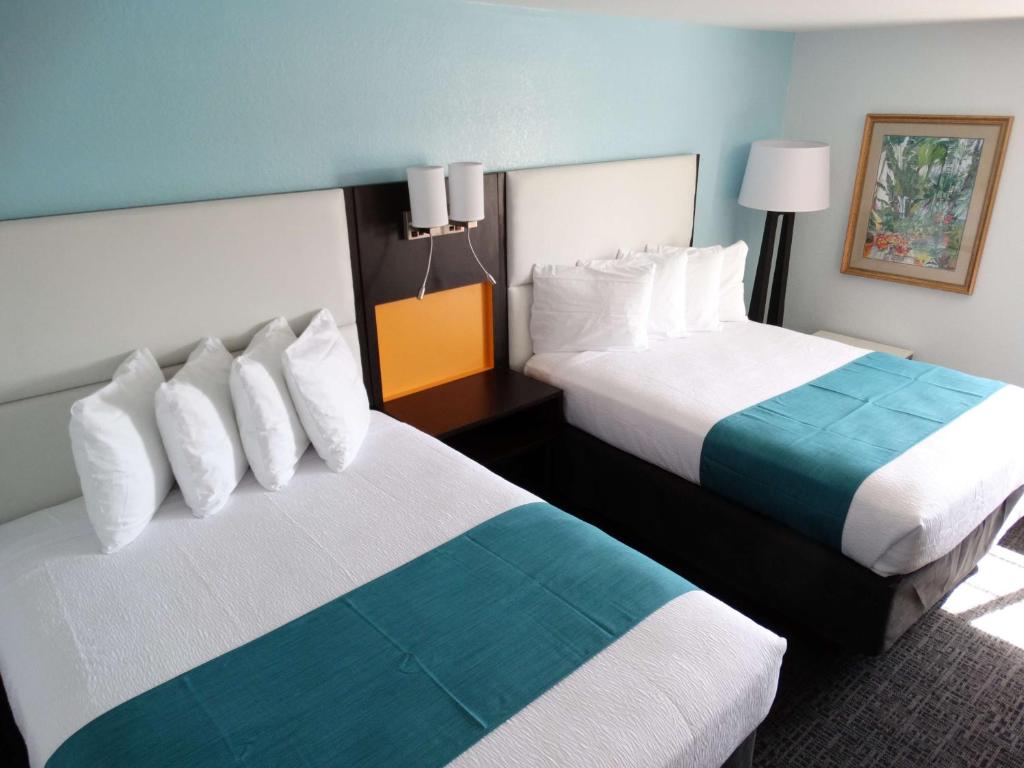 a hotel room with two beds in a room at Best Western Plus Orlando Lake Buena Vista South Inn & Suites in Kissimmee