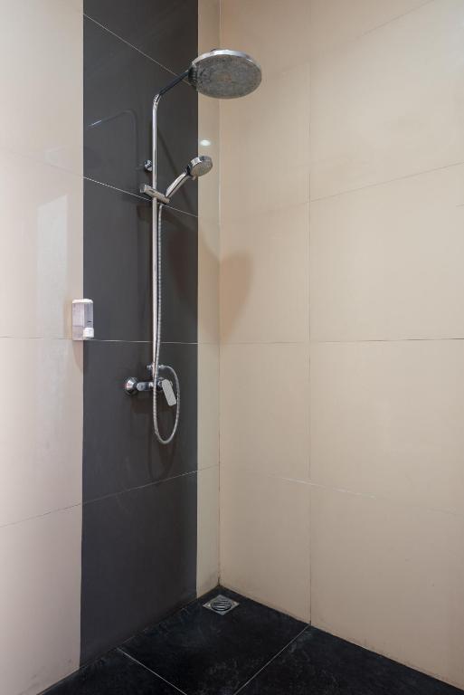 a shower with a shower head in a bathroom at Villa Melasti Wardana in Uluwatu