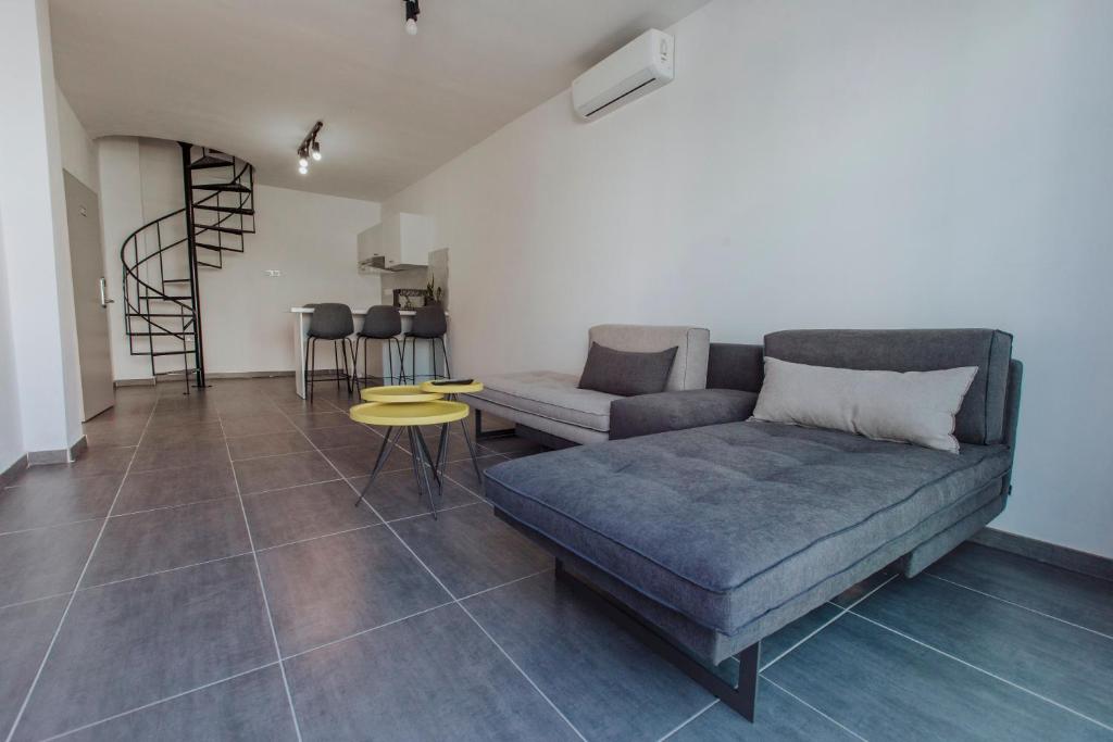 a living room with a couch and a table at River View Boutique Apts in Ayia Napa