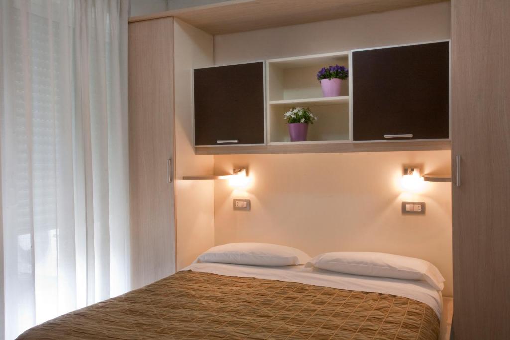 A bed or beds in a room at Residence Il Tulipano
