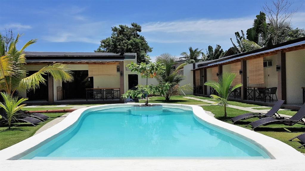 a swimming pool in the yard of a house at Positano Alona Beach Panglao in Panglao Island