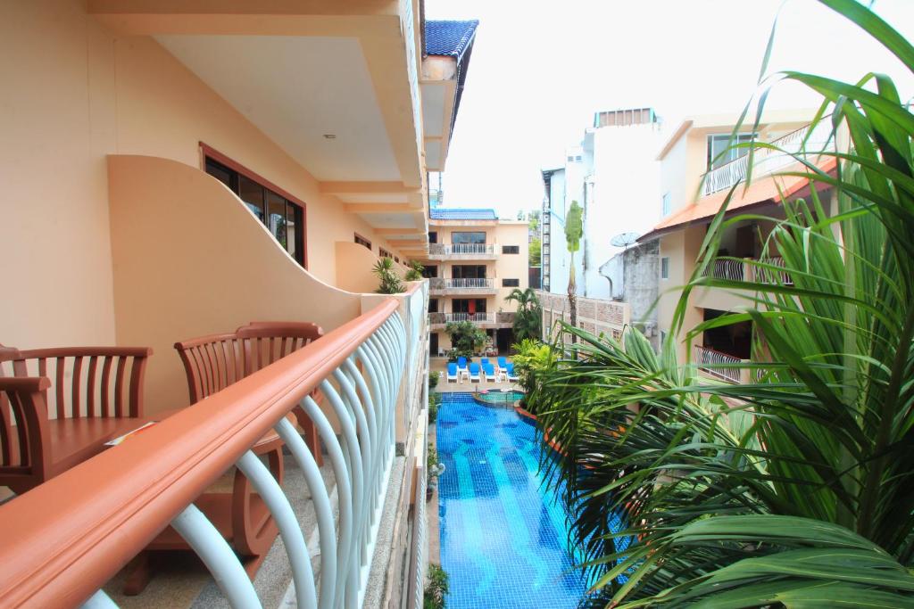 a balcony with a swimming pool and plants at Baan Boa Resort in Patong Beach
