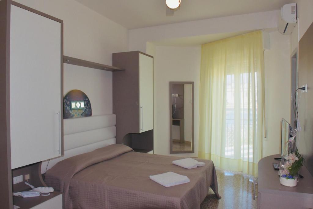 Postel nebo postele na pokoji v ubytování Hotel Astoria