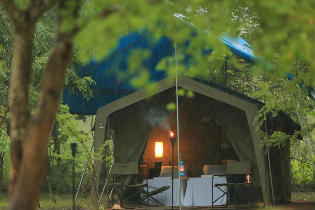 a tent with a table and a fire in it at Big Game - Wilpattu by Eco Team in Wilpattu