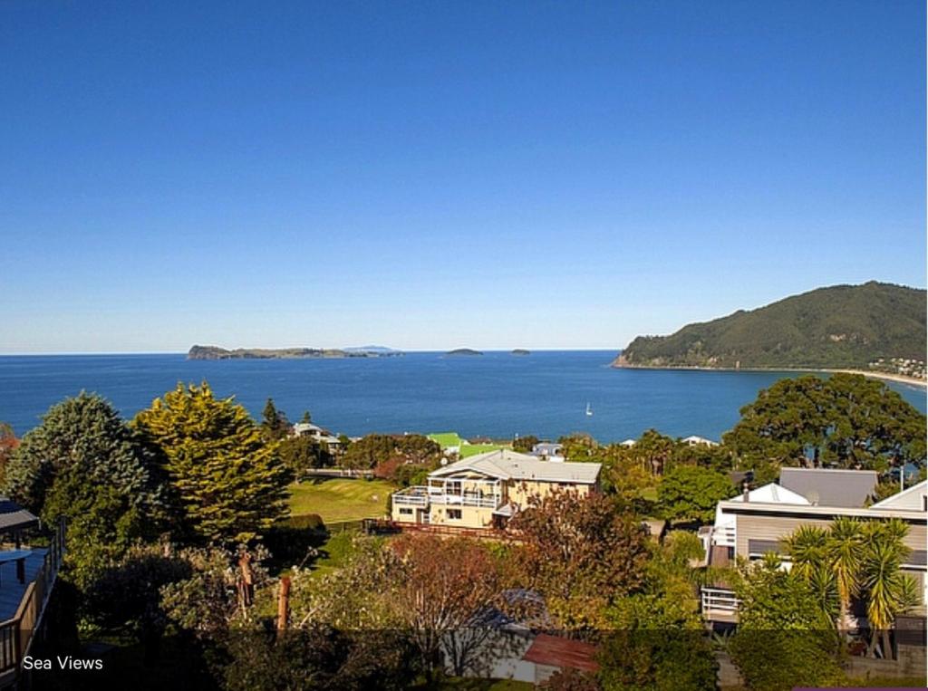 a view of the ocean from a house at Pretty on Paku, Tairua - Cottage in Tairua