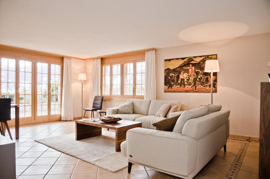 a living room with a couch and a table at Apartment Paradise - GRIWA RENT AG in Grindelwald