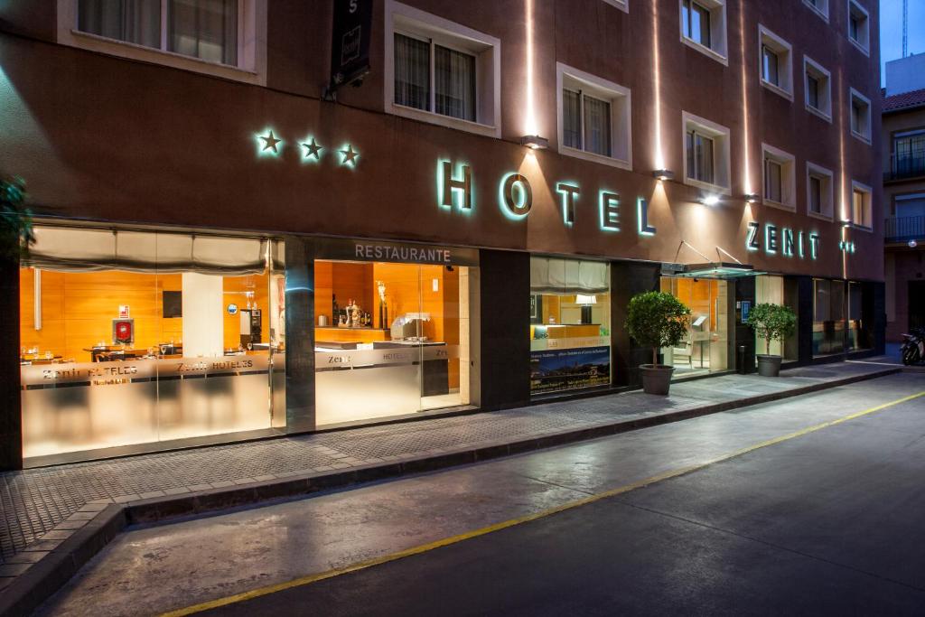 a store front of a hotel at night at Zenit Málaga in Málaga