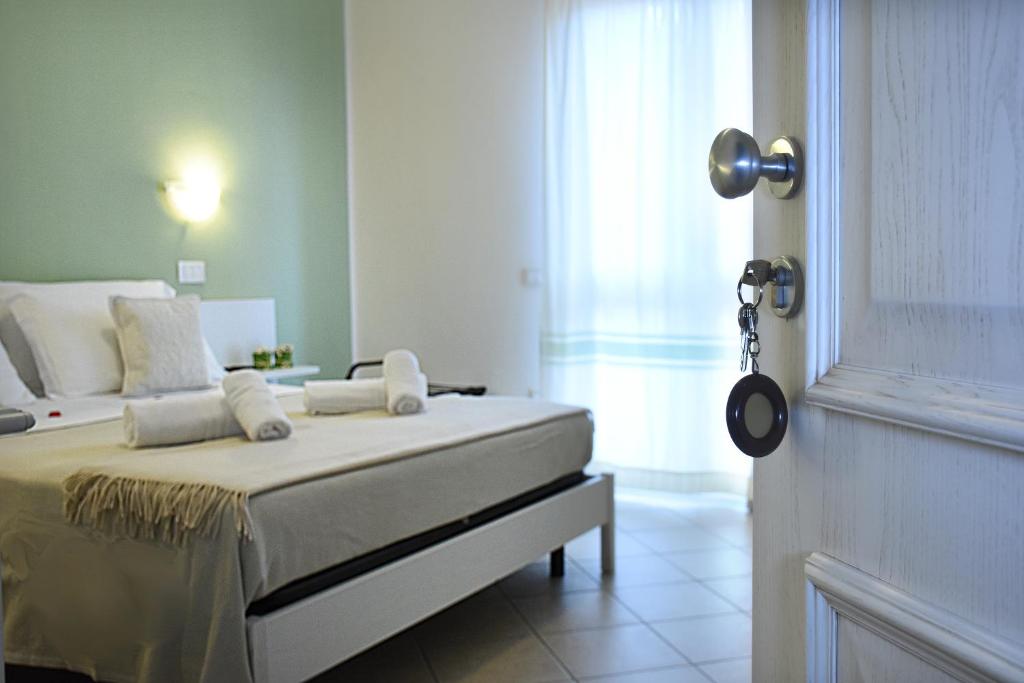 Postel nebo postele na pokoji v ubytování Hotel Stella D'Oro