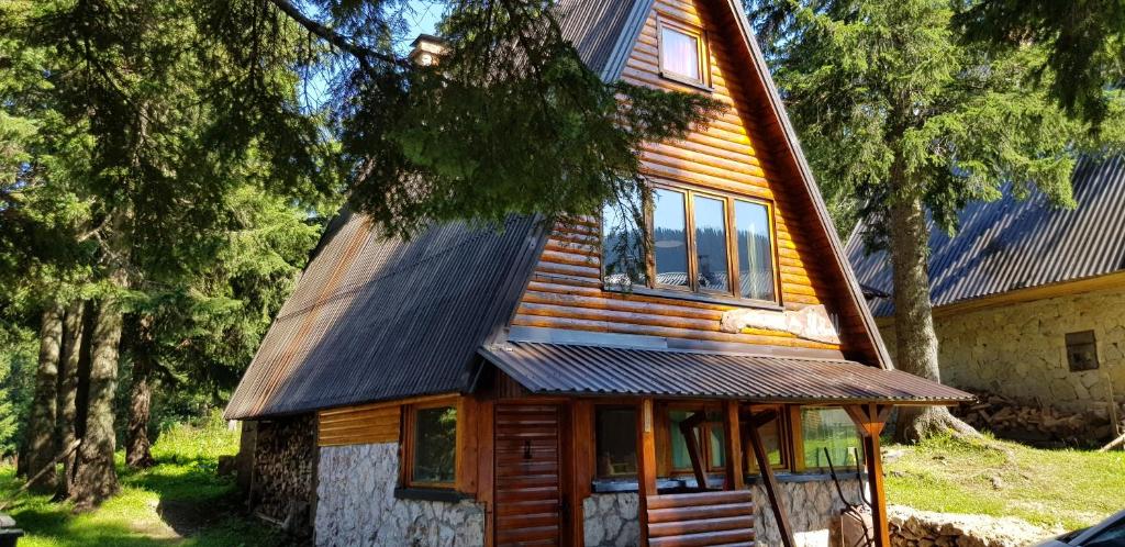 a wooden house with a gambrel roof at Snow Angel Jahorina in Jahorina