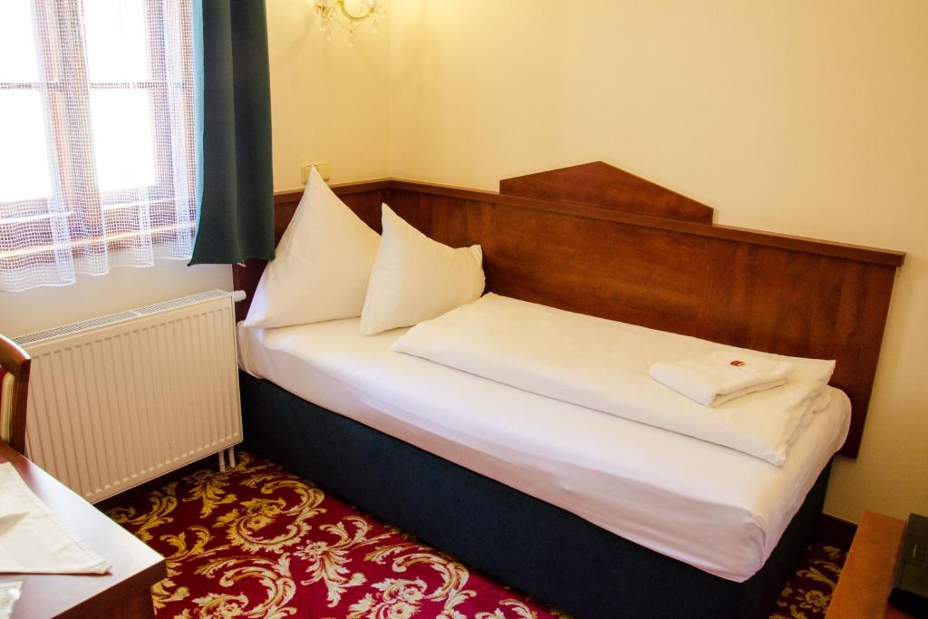 Postel nebo postele na pokoji v ubytování Hotel Fortna