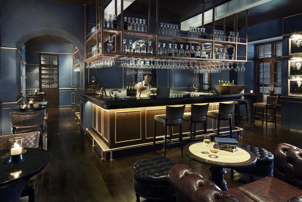 a restaurant with a bar with tables and chairs at Anantara Chiang Mai Resort in Chiang Mai