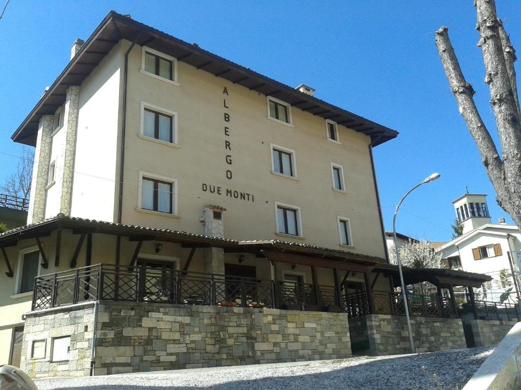 a large building with a sign for the blue room at Albergo Due Monti in Ateleta