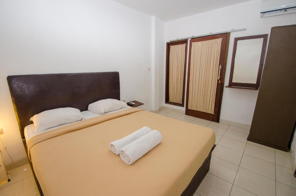 Postel nebo postele na pokoji v ubytování Taman Sari Cottages