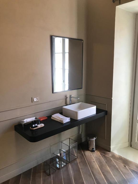 a bathroom with a sink and a mirror at Suites Menaggio in Menaggio