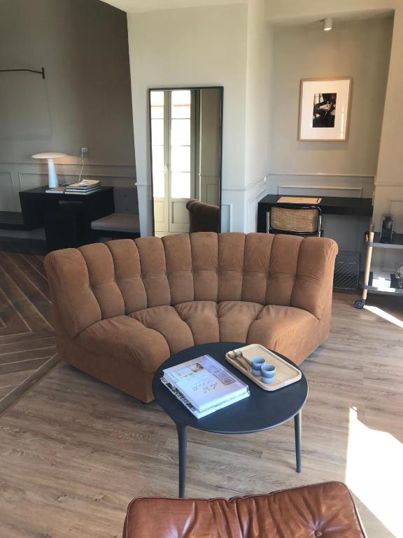 a living room with a brown couch and a table at Suites Menaggio in Menaggio
