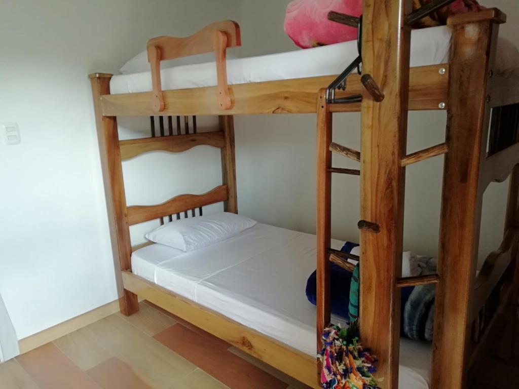 a bedroom with two bunk beds in a room at Elizabetha Hostal in Salento