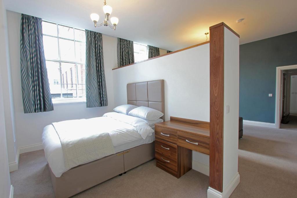1 dormitorio con 1 cama, escritorio y ventanas en The Castle Collection - 3 Union Court en Liverpool