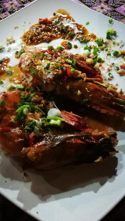 two pieces of food on a white plate at PP Red Tuna Hut in Phi Phi Don