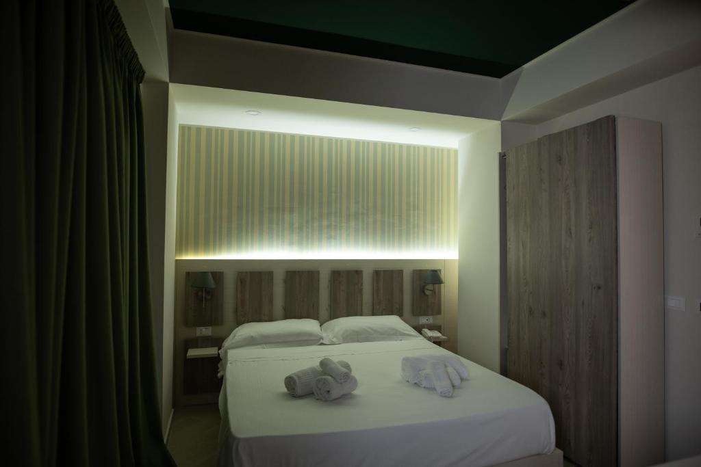 Postel nebo postele na pokoji v ubytování Hotel Cliché
