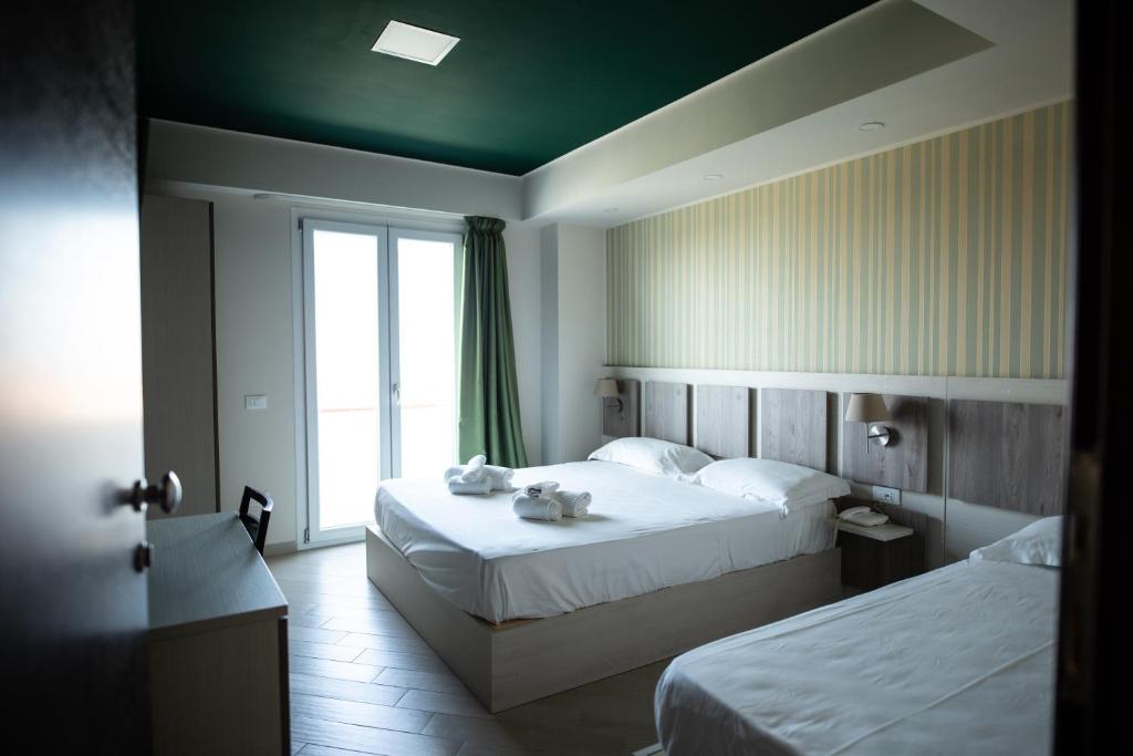 Postel nebo postele na pokoji v ubytování Hotel Cliché