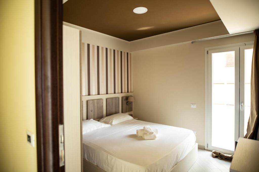 Postel nebo postele na pokoji v ubytování Hotel Cliché