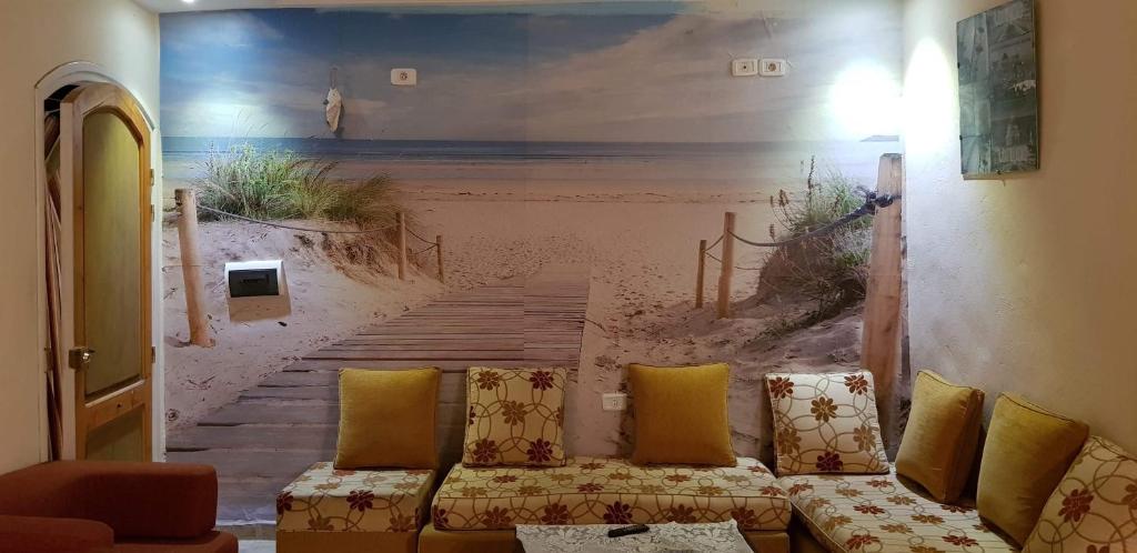 a room with a mural of a beach at Douja Apartment in Nabeul