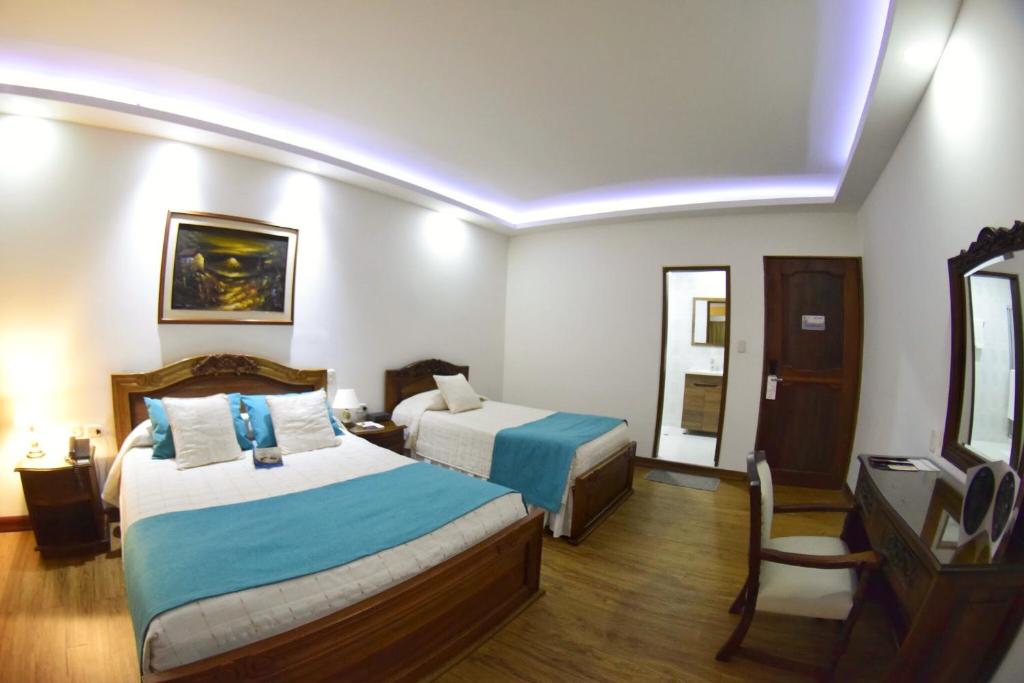 Postel nebo postele na pokoji v ubytování El Gran Hotel de Pereira